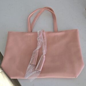 New w/tag never used Light pink tote bag w/ 2 hanging tassles wrapped in plastic